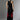 Men's black sleeveless tank top paired with oversized black pants featuring red dragon embroidery, showcasing a stylish streetwear look from the back.