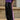 Men's streetwear pants in black and purple with white detailing, featuring a loose fit and side pockets, styled with a casual top and sneakers.