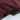 close-up of a burgundy t-shirt fabric showing soft texture and rolled hem details