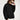 Unisex black oversized polo sweatshirt with long sleeves, styled with a white inner layer and accessorized with black sunglasses.